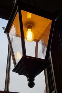 Low angle view of illuminated lamp against sky