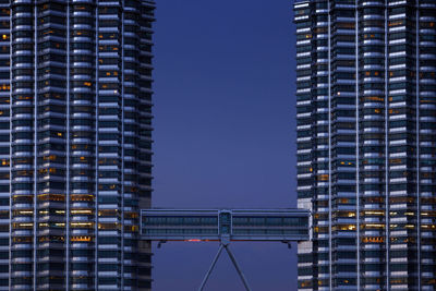 Malaysia, kuala lumpur, skyway connecting both petronas towers at dusk