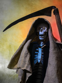 A skeleton with cape and scythe symbolizes death