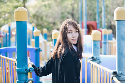 Portrait of smiling young woman standing outdoors