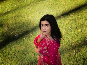 Portrait of beautiful young woman standing outdoors indian bride .