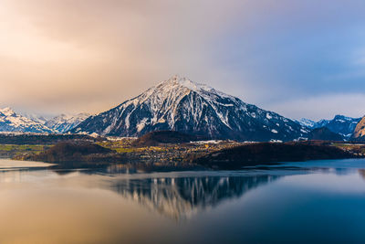 Scenic view of lake thun against sky during sunset