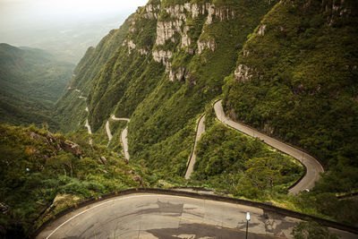 High angle view of road amidst trees against sky