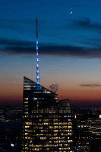 Illuminated buildings against sky at night