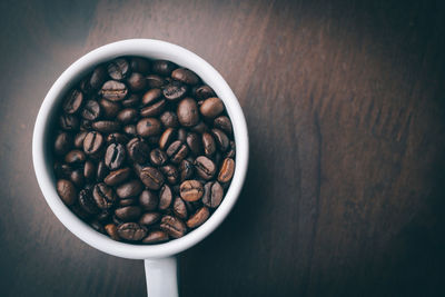 High angle view of coffee beans in bowl on table