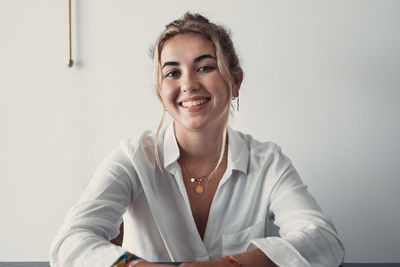 Portrait of young woman using laptop at home