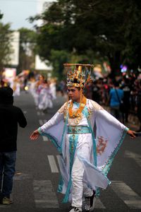 People performing on street in city