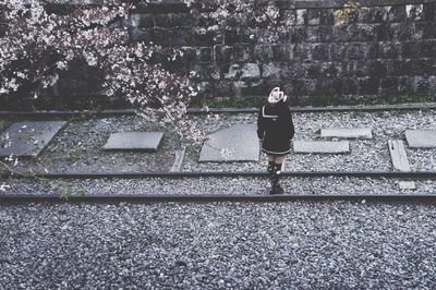 Full length of woman standing on railing