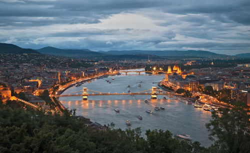 High angle view of illuminated city at riverbank