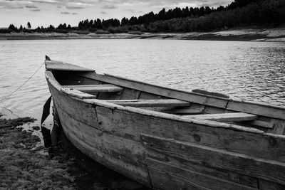 Boat moored on lake shore