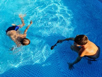 High angle view of people swimming in pool