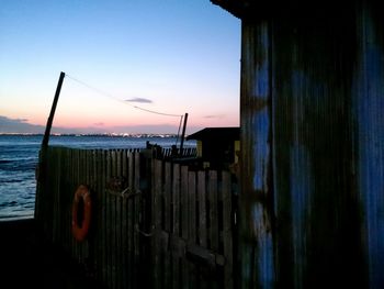 Pier on sea at sunset