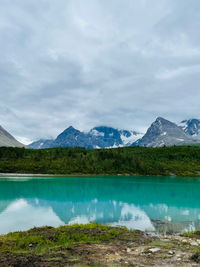 Scenic view of lake and mountains against sky