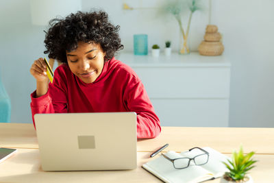 Young woman using laptop at home