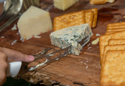 Close-up of hand holding cutting board