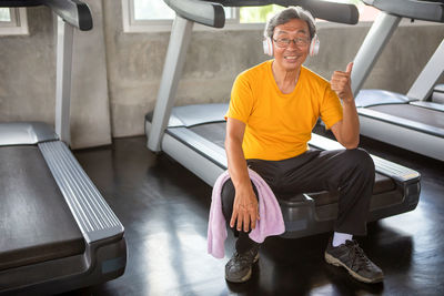 Portrait of a smiling man sitting in corridor