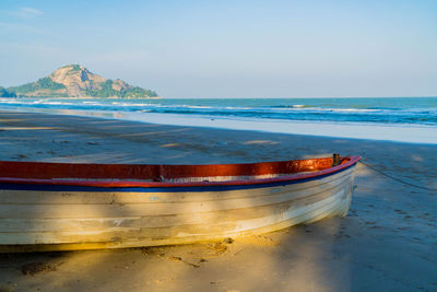 An old fishing boat on the beach with sea background. sea coast line. copy space for text.