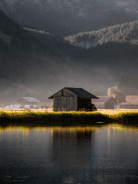 Scenic view of lake by mountains against sky