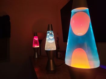 Close-up of illuminated lamp on table at home