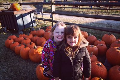 Portrait of a smiling young woman with pumpkins