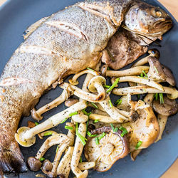 High angle view of cooked fish and vegetables in plate