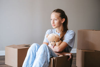 Portrait of young woman sitting on sofa at home