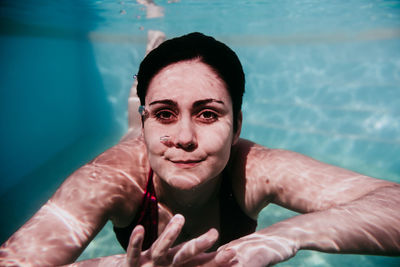 Portrait of man swimming in pool