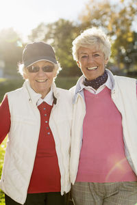 Portrait of smiling female golfers outdoors