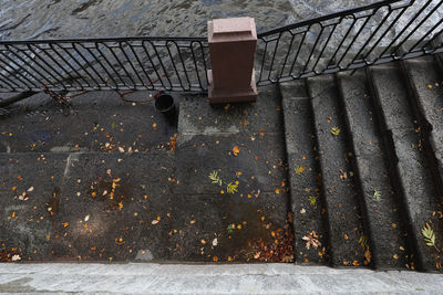High angle view of metal railing on footpath