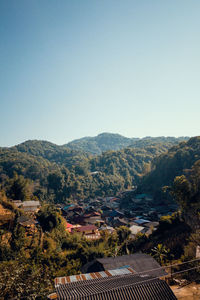 High angle view of townscape and mountains against clear sky