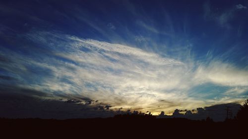 Silhouette landscape against sunset