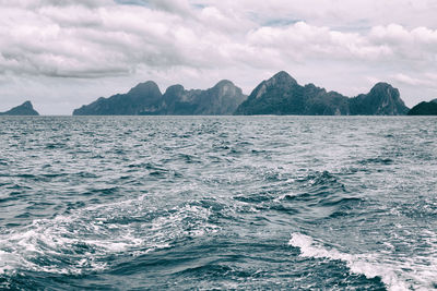 Scenic view of sea and mountains against sky