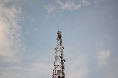 Low angle view of communications tower against sky