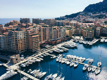 High angle view of buildings by sea against sky