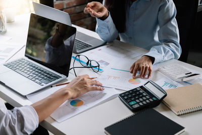 High angle view of people working on table