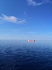 Scenic view of sea against blue sky