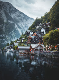 Scenic view of lake by buildings against sky