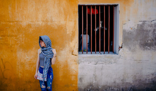 Woman looking through window