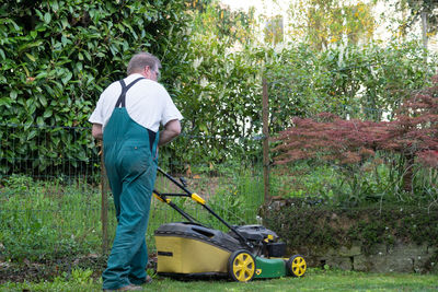 Rear view of man working on field