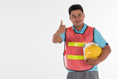 Portrait of smiling man standing against white background