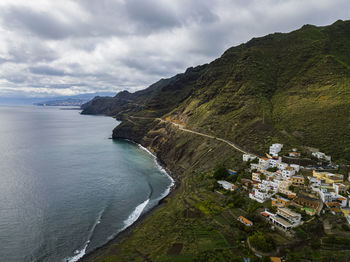 High angle view of sea and buildings against sky