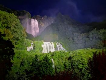 Scenic view of waterfall against sky