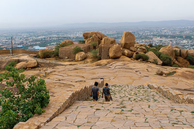 People on the wall of a historical building