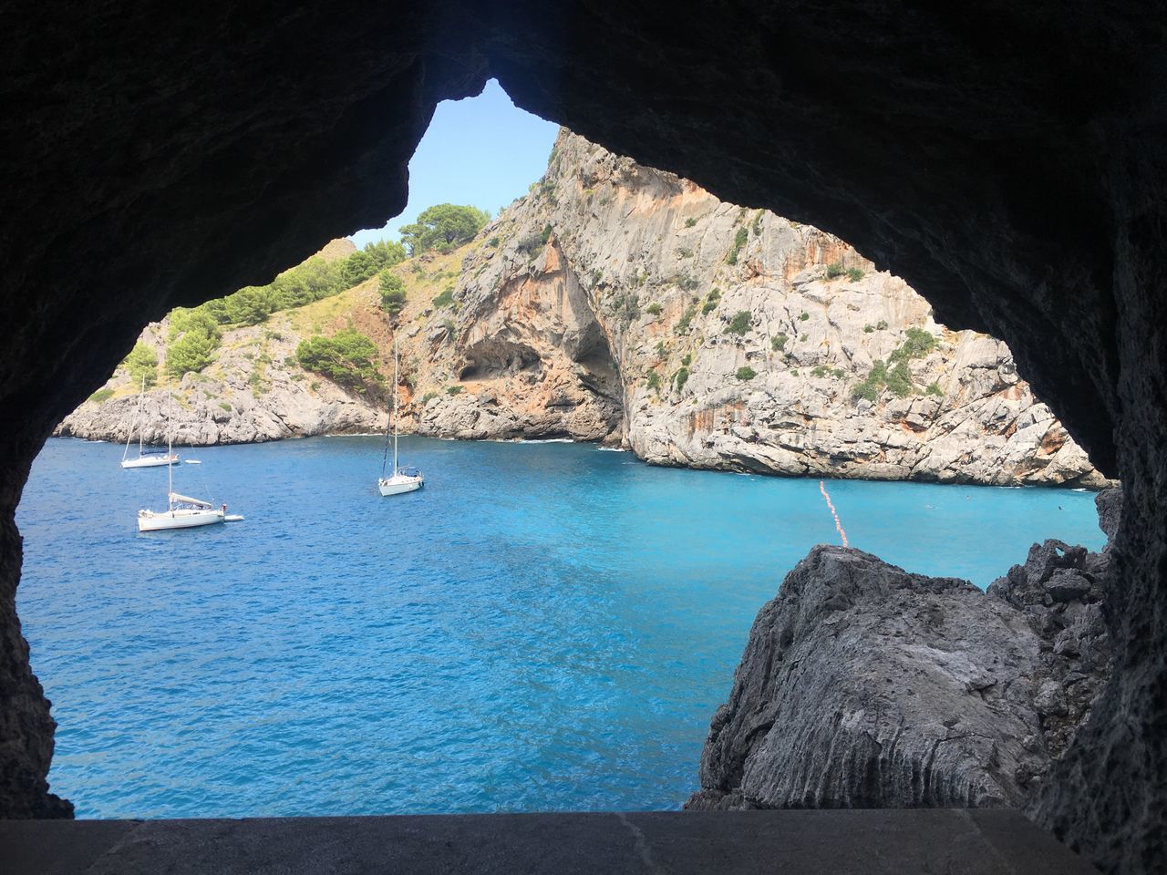 rock formation, rock - object, sea, water, scenics, nature, beauty in nature, cliff, natural arch, tranquil scene, mountain, physical geography, geology, arch, tranquility, day, rock, travel destinations, no people, idyllic, outdoors, cave, sunlight, rock face, sky