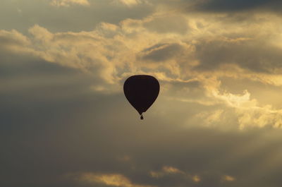 Low angle view of hot air balloon against sky during sunset