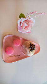 Close-up of pink rose on table