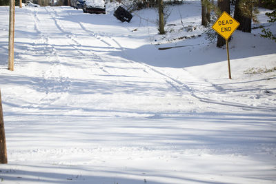 Road sign on snow covered field