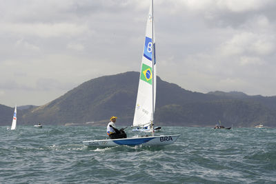 People on sea against sky