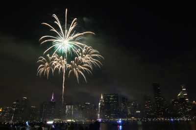 Low angle view of firework display at night