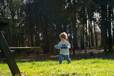 Rear view of boy on field